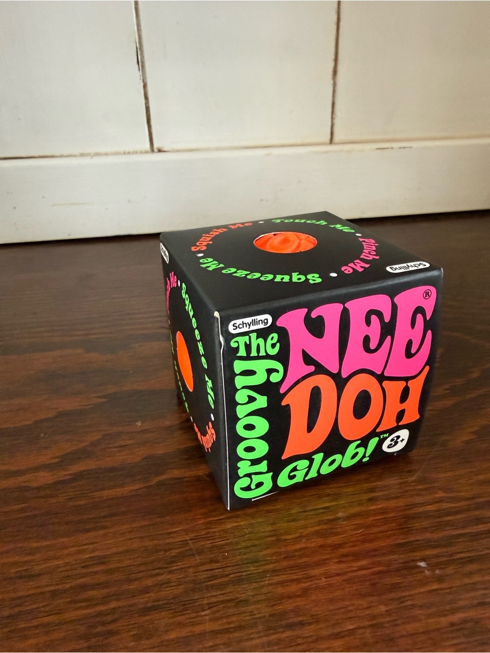 Schylling Nee Doh Groovy Glob Squishy Toy - Black with Pink & Orange